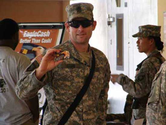 photo of Soldier proudly display EagleCash Card
