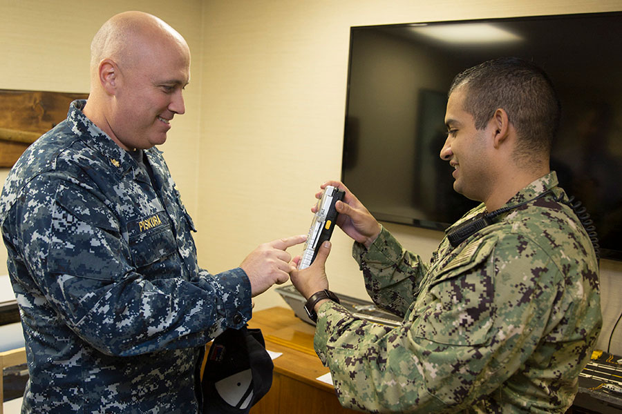 Navy staff look at device